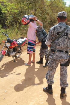 pau brasil, bahia / brazil - may 3, 2012: National Force military personnel approach vehicles and people traveling in rural Pau Brasil after armed conflict between Pataxo Hahahae ethinics and farmers.