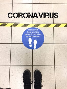 social distancing for Coronavirus covid-19 in supermarket to government guidelines for distance to avoid spread of virus pathogen