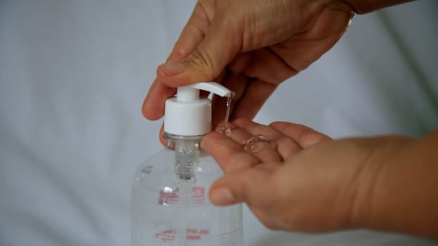 salvador, bahia / brazil - may 6, 2020: person is seen using alcohol gel hand hygiene to protect against Corona Virus.