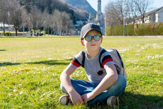 a young boy with the basilica of Lourdes in France