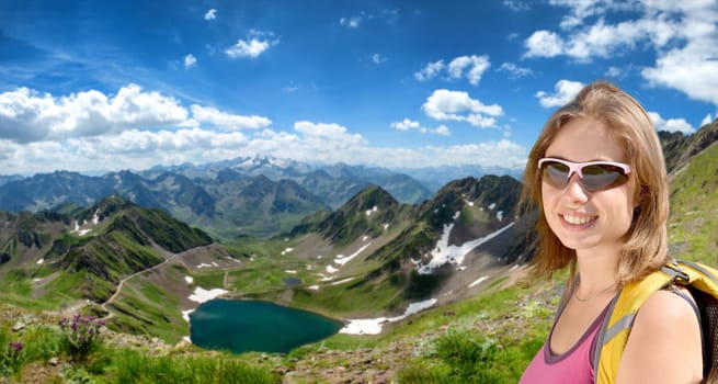 a young woman hiker and lake Oncet in the french mountains pyrenees