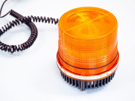 the Orange rotating beacon on white reflective background.