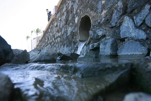 salvador, bahia / brazil - january 12, 2015: Sewerage and view pouring fluids on the sand of Amaralina beach in Salvador.