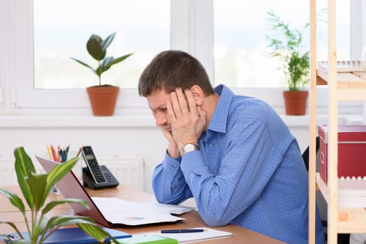 A man watching a report with a bad investment