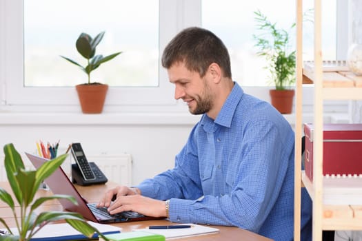 Successful businessman works in the computer at the office