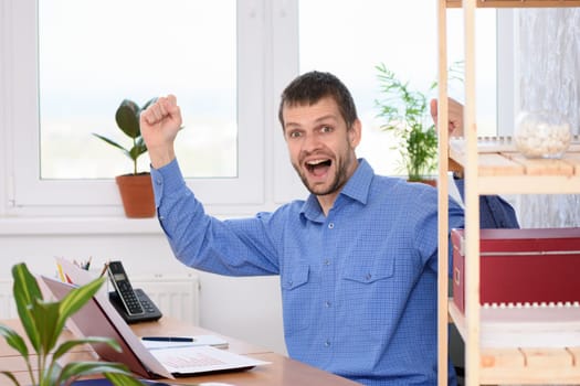 Businessman in the office is very happy about a successful deal