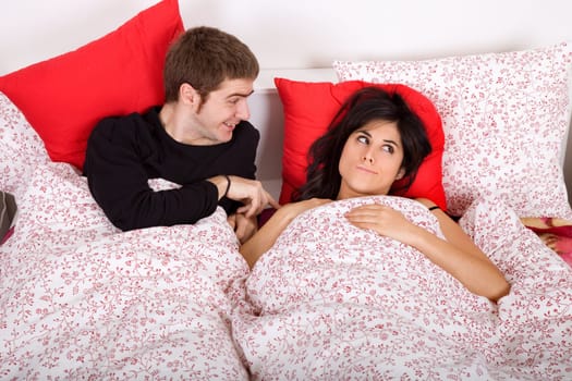 young happy couple in bed, studio picture .