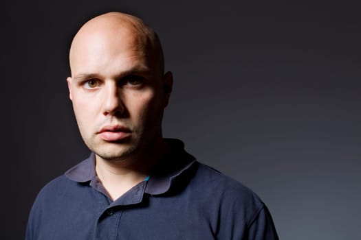 Portrait of young man thinking on a black background