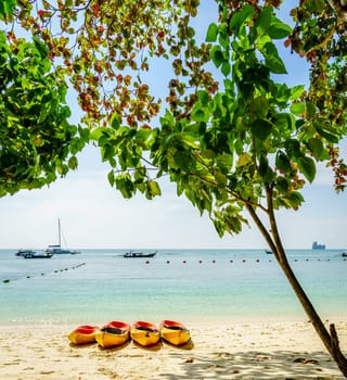 Kayaks on an empty beach on an island in Krabi, Thailand