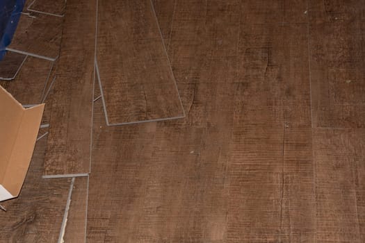 Laminate flooring. Threaded panel of a laminate floor on a thermally insulated floor. Electric underfloor heating, radiant heating, infrared carbon heating foil for the floor