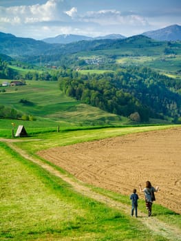 Mother and son hiking through the beautiful countryside of Neuheim in the Canton of Zug, Switzerland.