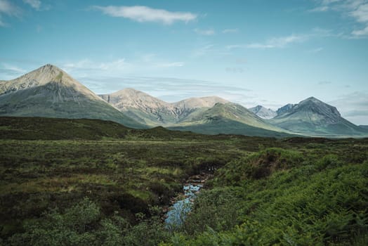 Beautiful landscape of the highlands in Scotland with mountains and a river
