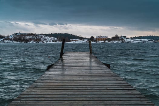 Old pier in Oslo goes to open sea in a cloudy day with wind