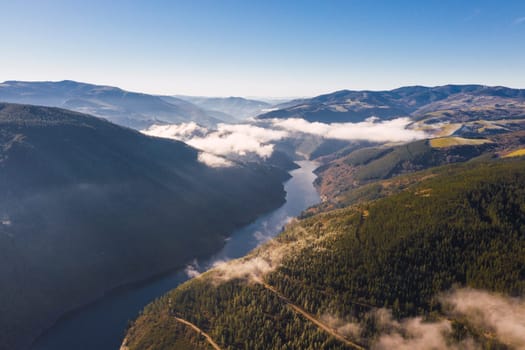 Landscape a river with fog and mountains in a clear day