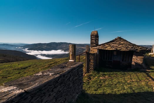 Beautiful landscape of grasslands fields with slate house