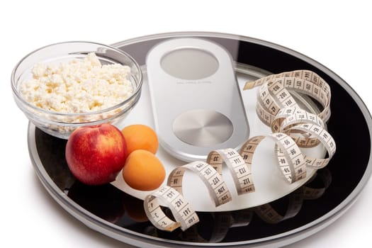 Slimming, diet, and control of weight. Still life with healthy food, scales and measuring tape. Healthy nutrition. Healthy lifestyle concept. Control of weight during the isolation period