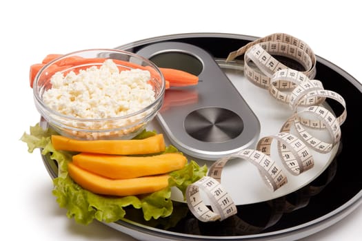 Slimming, diet, and control of weight. Still life with healthy food, scales and measuring tape. Healthy nutrition. Healthy lifestyle concept. Control of weight during the isolation period