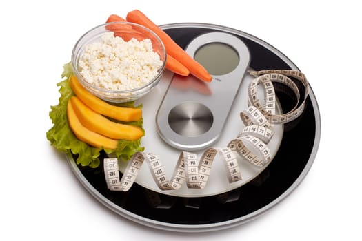 Slimming, diet, and control of weight. Still life with healthy food, scales and measuring tape. Healthy nutrition. Healthy lifestyle concept. Control of weight during the isolation period