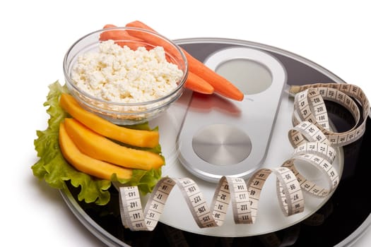 Slimming, diet, and control of weight. Still life with healthy food, scales and measuring tape. Healthy nutrition. Healthy lifestyle concept. Control of weight during the isolation period