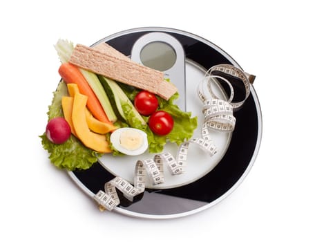 Slimming, diet, and control of weight. Still life with healthy food, scales and measuring tape. Healthy nutrition. Healthy lifestyle concept. Control of weight during the isolation period