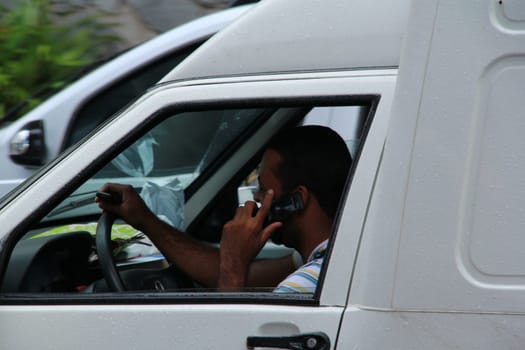 salvador, bahia / brazil - octuber 5, 2012: Driver is seen using the mobile device while driving in the city of Salvador .