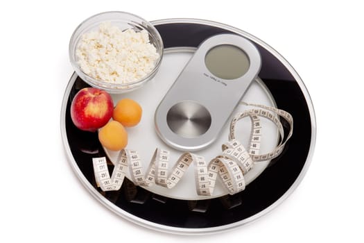 Slimming, diet, and control of weight. Still life with healthy food, scales and measuring tape. Healthy nutrition. Healthy lifestyle concept. Control of weight during the isolation period