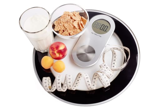Slimming, diet, and control of weight. Still life with healthy food, scales and measuring tape. Healthy nutrition. Healthy lifestyle concept. Control of weight during the isolation period