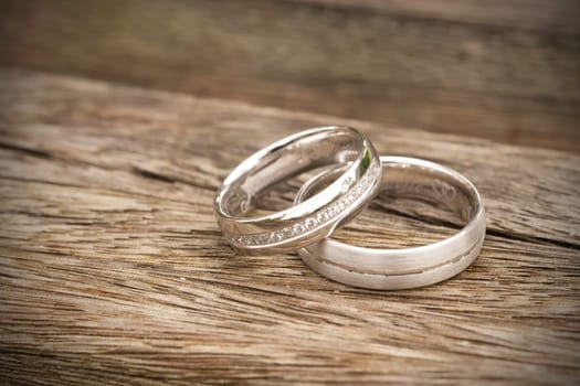 silver wedding rings on wooden underground