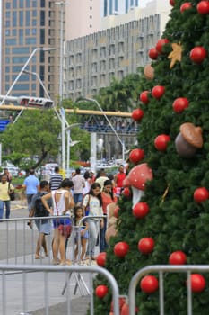 salvador, bahia / brazil - december 19, 2013: People are seen near the Christmas tree in Nilton Rique Square, facing the Iguatemi Shopping Mall in Salvador.