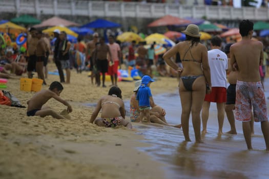 salvador, bahia / brazil - december 29, 2013: People are seen at Porto da Barra beach in the city of Salvador.
