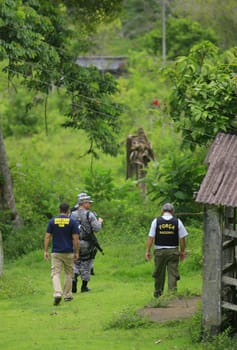 ilheus, bahia / brazil - february 15, 2014: National Force agents survey armed conflict area between farmers and Tupinamba Indians in rural Ilheus.
