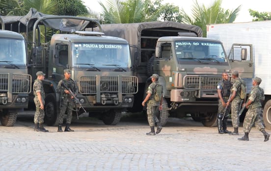 buerarema, bahia / brazil - february 14, 2014: Army soldiers patrol the streets of Buerarema City Center due to series of conflicts involving Tupinamba ethnic Indians and local farmers..