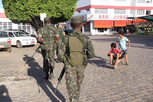 buerarema, bahia / brazil - february 14, 2014: Army soldiers patrol the streets of Buerarema City Center due to series of conflicts involving Tupinamba ethnic Indians and local farmers..