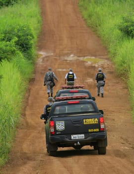 ilheus, bahia / brazil - february 15, 2014: National Force agents survey armed conflict area between farmers and Tupinamba Indians in rural Ilheus.