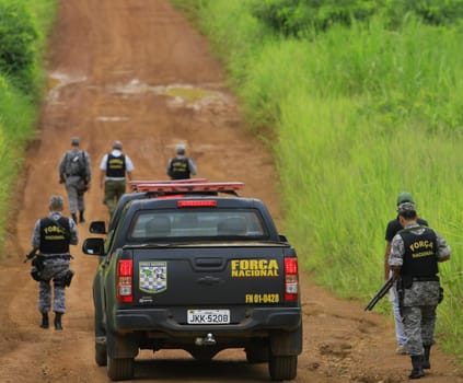ilheus, bahia / brazil - february 15, 2014: National Force agents survey armed conflict area between farmers and Tupinamba Indians in rural Ilheus.