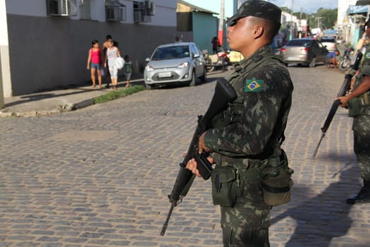 buerarema, bahia / brazil - february 14, 2014: Army soldiers patrol the streets of Buerarema City Center due to series of conflicts involving Tupinamba ethnic Indians and local farmers..
