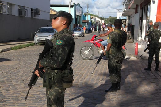 buerarema, bahia / brazil - february 14, 2014: Army soldiers patrol the streets of Buerarema City Center due to series of conflicts involving Tupinamba ethnic Indians and local farmers..