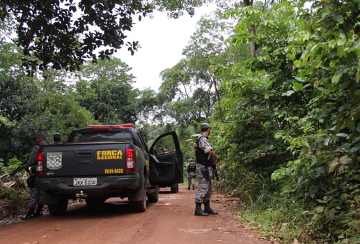 ilheus, bahia / brazil - february 15, 2014: National Force agents survey armed conflict area between farmers and Tupinamba Indians in rural Ilheus.