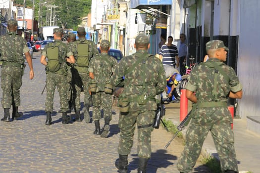 buerarema, bahia / brazil - february 14, 2014: Army soldiers patrol the streets of Buerarema City Center due to series of conflicts involving Tupinamba ethnic Indians and local farmers..