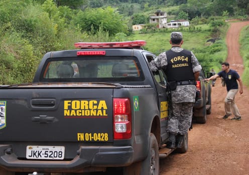 ilheus, bahia / brazil - february 15, 2014: National Force agents survey armed conflict area between farmers and Tupinamba Indians in rural Ilheus.