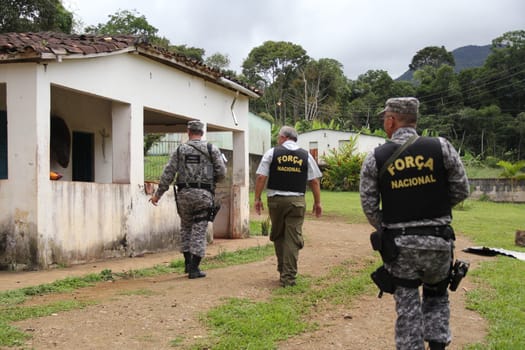 ilheus, bahia / brazil - february 15, 2014: National Force agents survey armed conflict area between farmers and Tupinamba Indians in rural Ilheus.