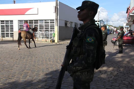 buerarema, bahia / brazil - february 14, 2014: Army soldiers patrol the streets of Buerarema City Center due to series of conflicts involving Tupinamba ethnic Indians and local farmers..