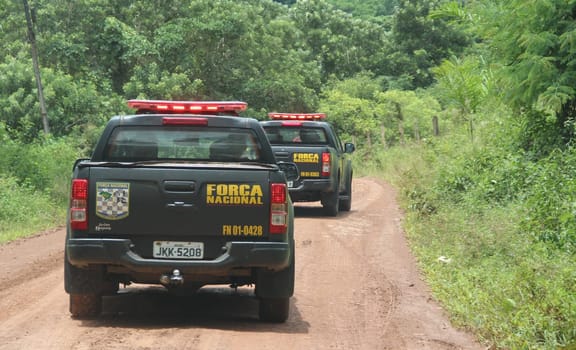 ilheus, bahia / brazil - february 15, 2014: National Force agents survey armed conflict area between farmers and Tupinamba Indians in rural Ilheus.