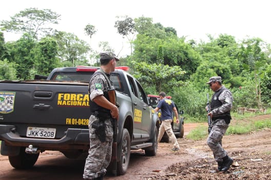 ilheus, bahia / brazil - february 15, 2014: National Force agents survey armed conflict area between farmers and Tupinamba Indians in rural Ilheus.