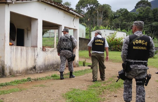 ilheus, bahia / brazil - february 15, 2014: National Force agents survey armed conflict area between farmers and Tupinamba Indians in rural Ilheus.