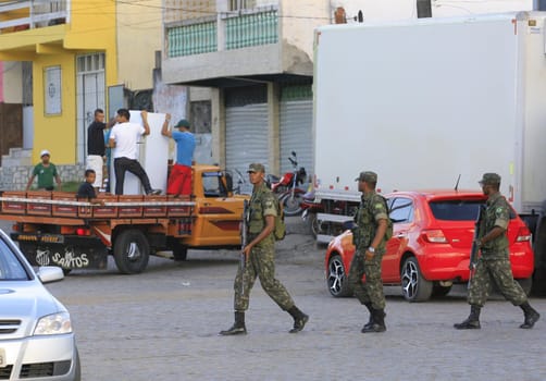 buerarema, bahia / brazil - february 14, 2014: Army soldiers patrol the streets of Buerarema City Center due to series of conflicts involving Tupinamba ethnic Indians and local farmers..