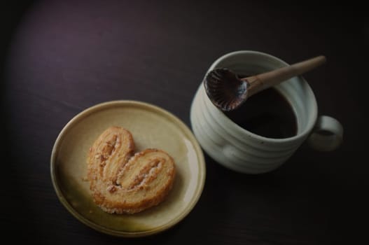 Cookies in the form of heart with coffee . Copy text menu food background.Effect brown filter