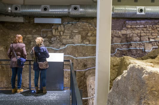 Cordoba, Spain - Dec 7th 2018: Visitors at Roman theatre remains inside Archaeological and Ethnological Museum of Cordoba, Spain