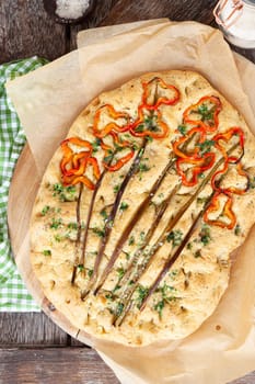 Homemade focaccia withe fresh bell peppers and herbs