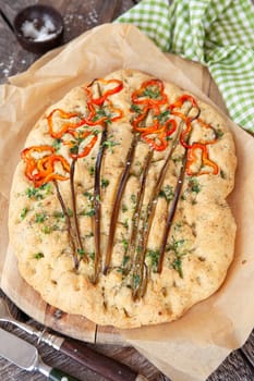 Homemade focaccia withe fresh bell peppers and herbs